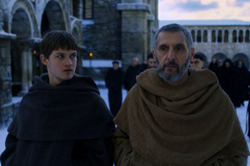 Damian Hardung (Adso de Melk) junto a Jhon Turturro (William de Baskerville)