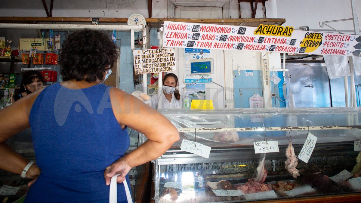 En pandemia, las carniceras del local respetan el protocolo y atienden con sus barbijos a los clientes que esperan en la puerta para ingresar por el límite de capacidad del lugar.