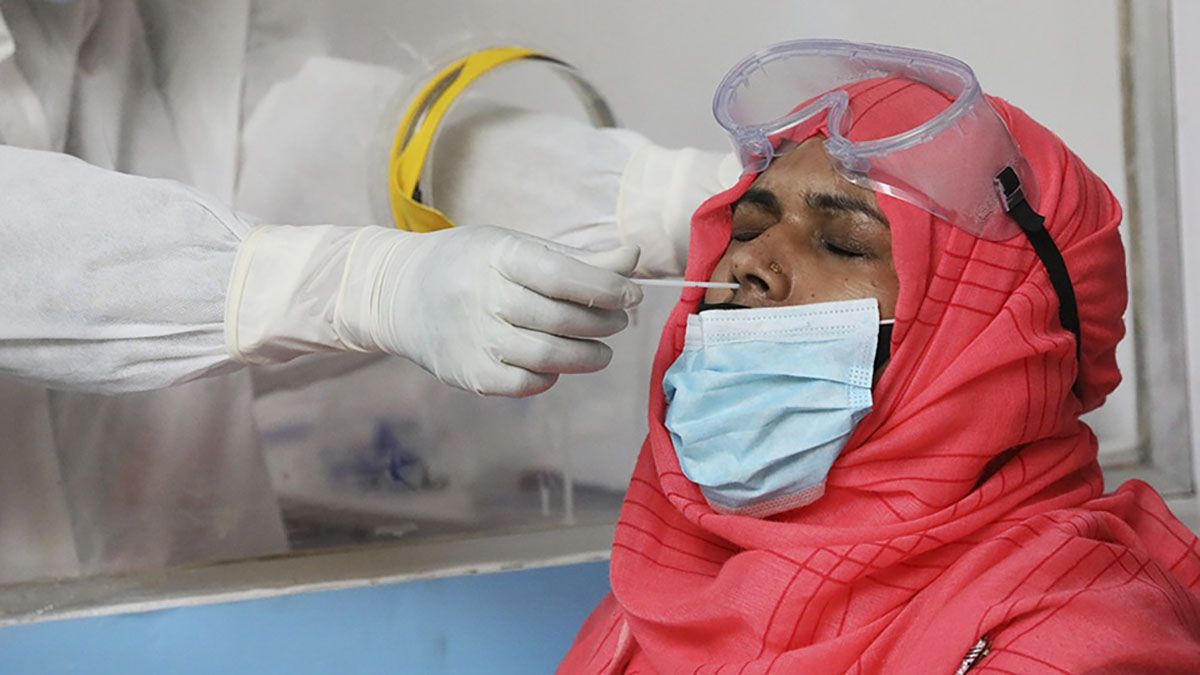 Un médico realiza un hisopado para detectar coronavirus en la India.