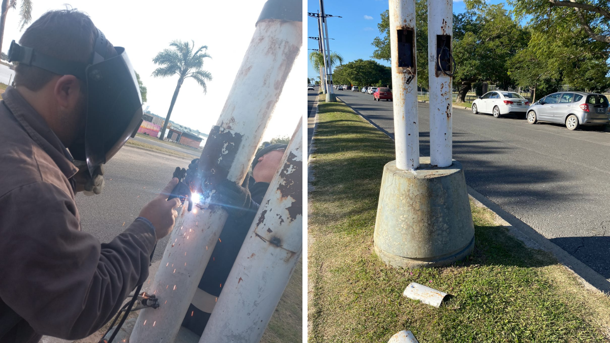 Operarios municipales reparan una columna de iluminación