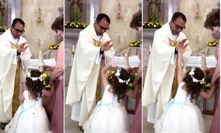 La reacción de la niña ante la la bendición del Sacerdote La reacción de la niña ante la la bendición del Sacerdote