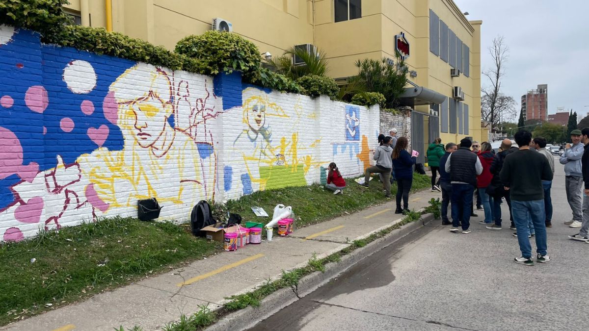 Estudiantes pintan un mural en el puerto para visibilizar la salud mental adolescente.