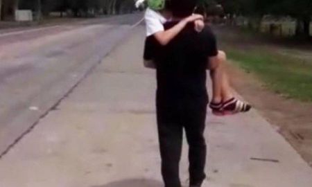 Tomó a su pequeña hija en brazos y cruzó el límite caminando. Captura del video Tomó a su pequeña hija en brazos y cruzó el límite caminando. Captura del video