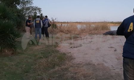 Policías y peritos de la Agencia de Investigación en la zona del hecho. De fondo, el cadaver envuelto en una lona. Policías y peritos de la Agencia de Investigación en la zona del hecho. De fondo, el cadaver envuelto en una lona.