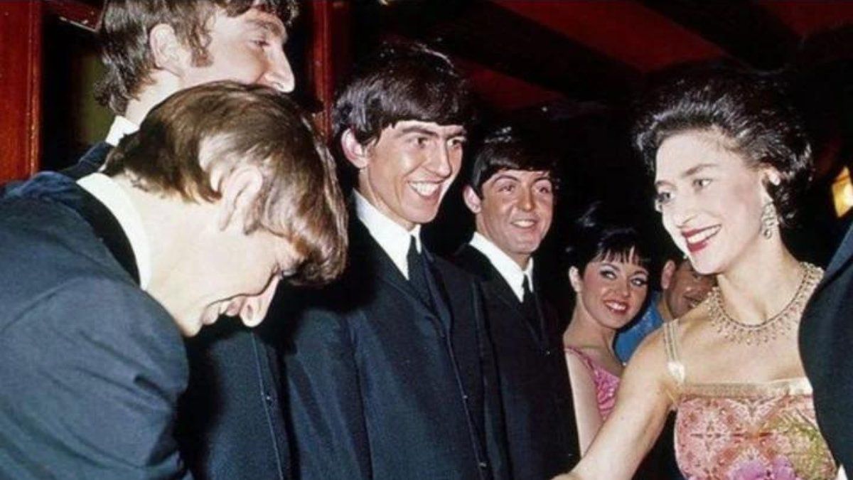 Ringo estrecha la mano de la Reina mientras que John