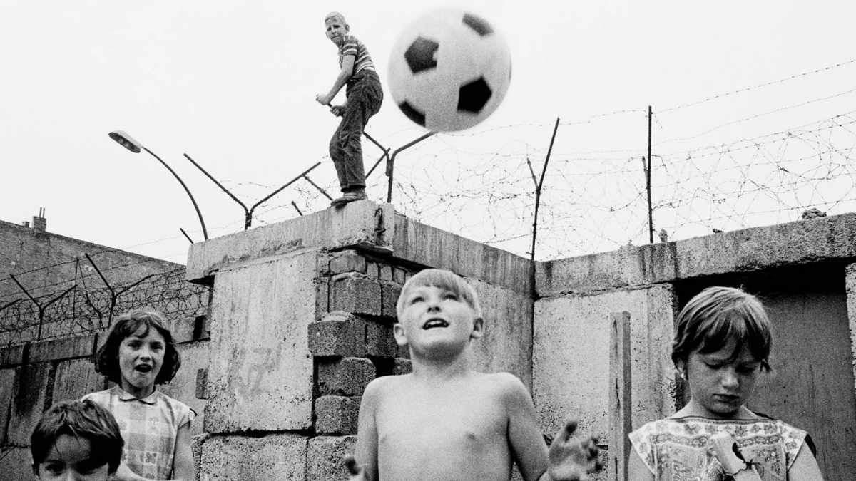 Niños juegan al fútbol en el muro de Berlín. Niños juegan al fútbol en el muro de Berlín.