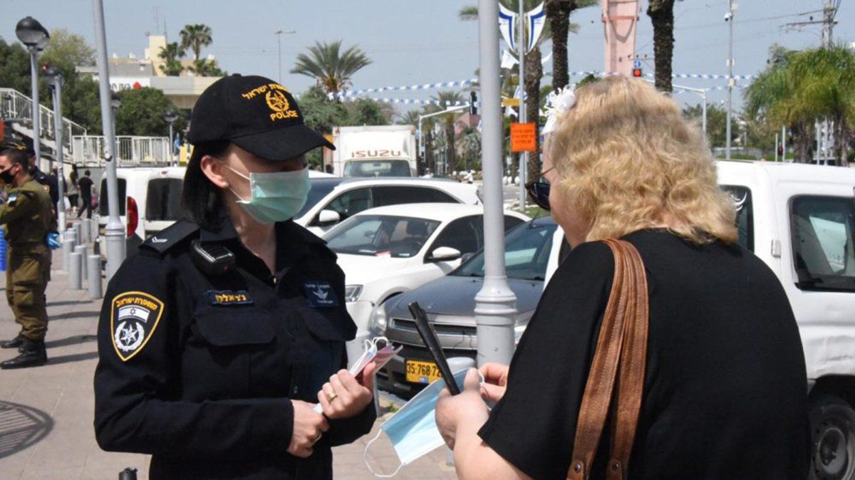 Una mujer policía en Israel controla los protocolos de prevención de coronavirus en la calle.