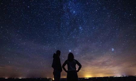 Dos personas ven a la Luna, Marte, Júpiter y Saturno en conjunción. Dos personas ven a la Luna, Marte, Júpiter y Saturno en conjunción.