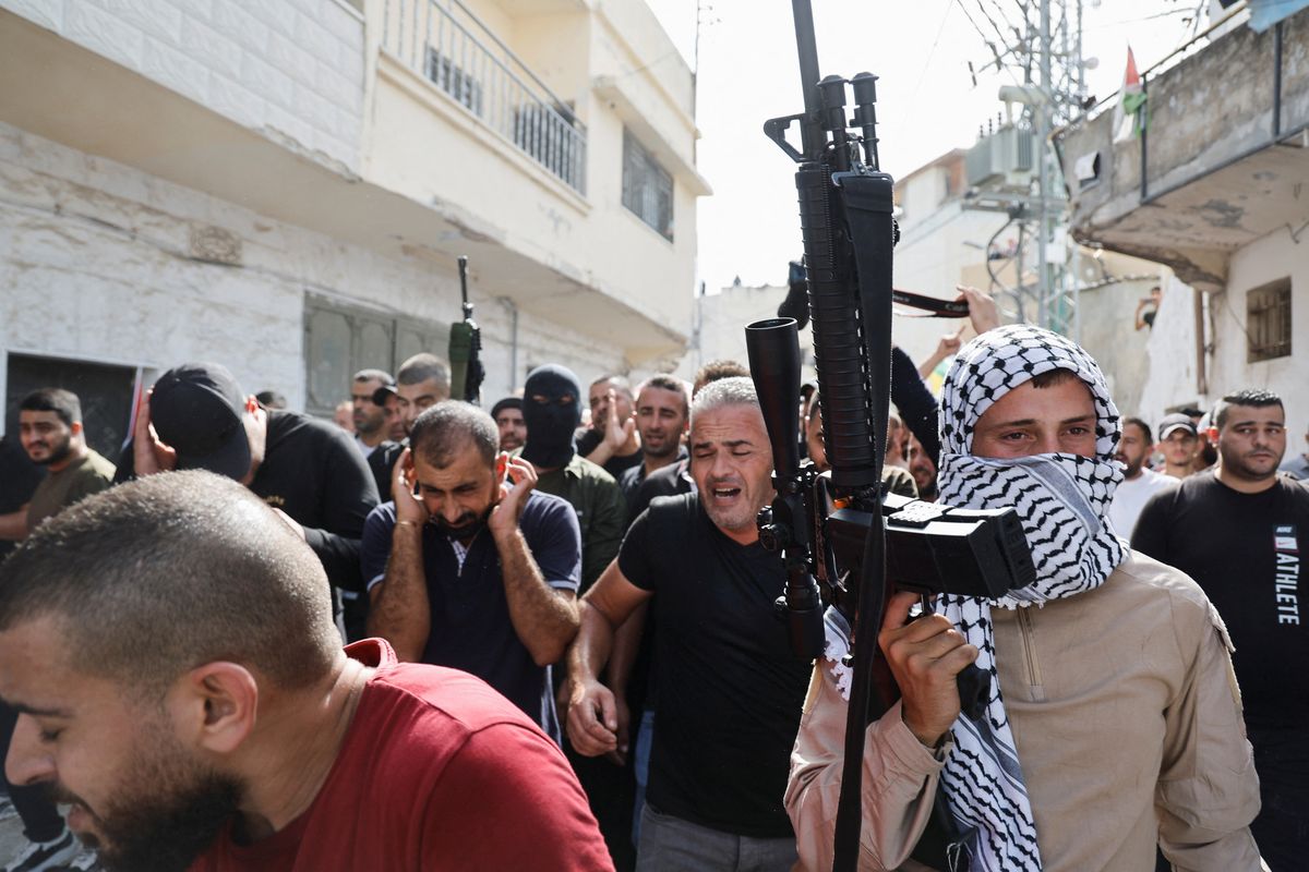 Hombres armados asisten a un funeral de palestinos que fueron asesinados por las fuerzas israelíes