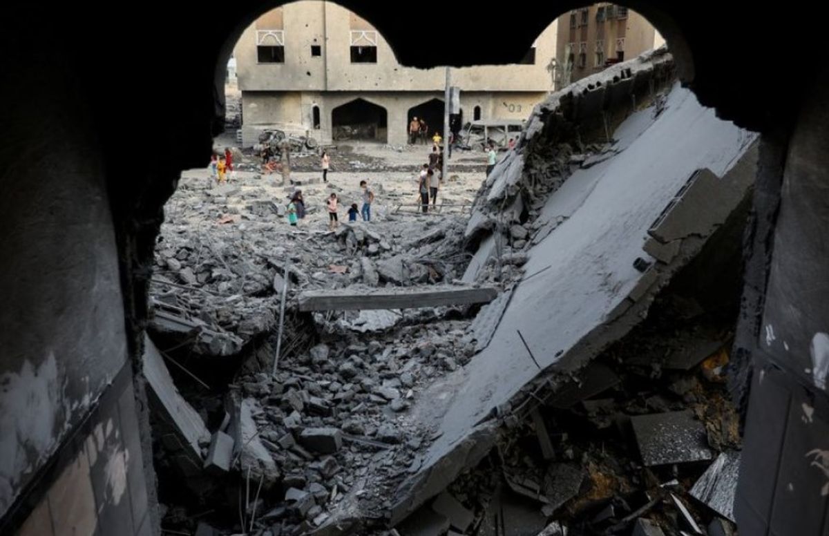 Palestinos inspeccionan el lugar de los ataques israelíes contra una casa en Khan Younis